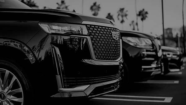 Line of premium black vehicles ready for chauffeur service