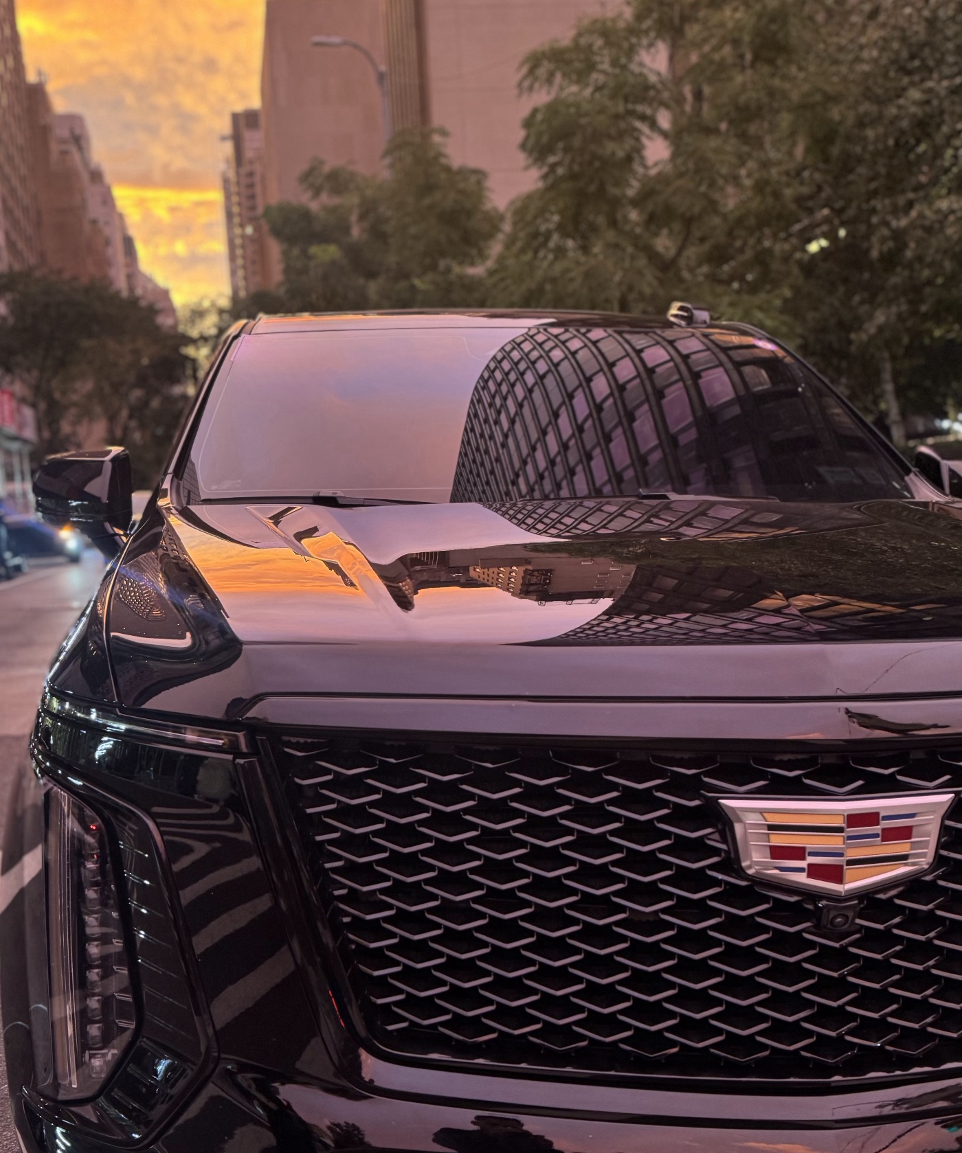 Limitless VIP Cadillac Escalade on a Manhattan avenue at sunset
